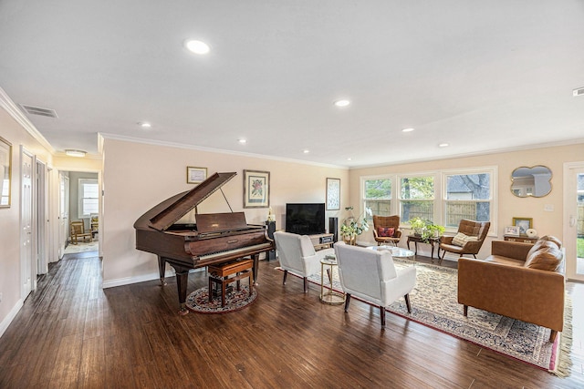 living area featuring crown molding, visible vents, a wealth of natural light, and wood finished floors