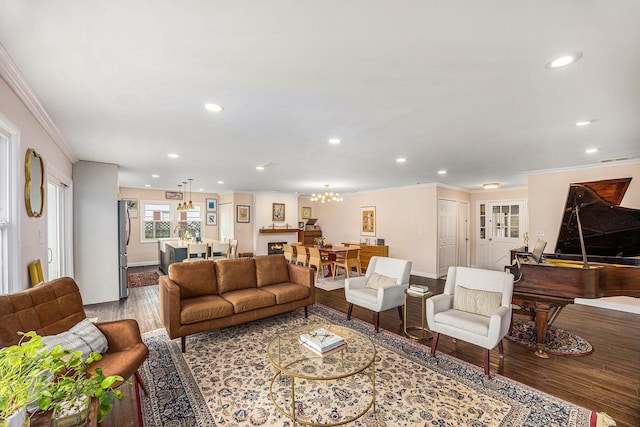 living area featuring recessed lighting, ornamental molding, and wood finished floors