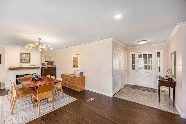 dining space featuring baseboards, wood finished floors, and a notable chandelier
