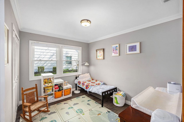 bedroom with baseboards, ornamental molding, and light wood-style flooring