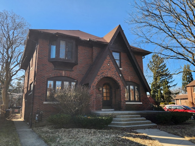 tudor-style house with brick siding