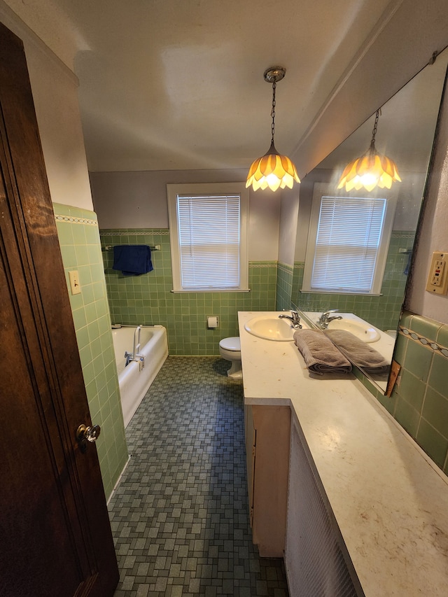 full bathroom featuring toilet, tile walls, a wainscoted wall, and vanity