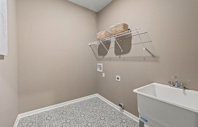 laundry area with a sink, washer hookup, tile patterned floors, laundry area, and baseboards