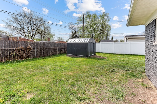 view of yard featuring a storage shed, an outbuilding, and a fenced backyard