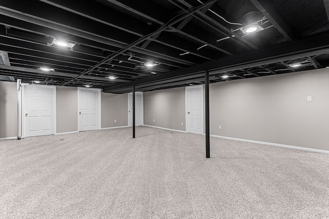 finished below grade area featuring carpet floors and baseboards