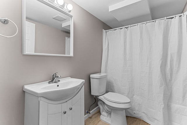 full bath featuring toilet, visible vents, wood finished floors, and vanity