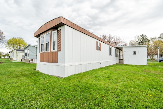 view of side of home featuring a yard