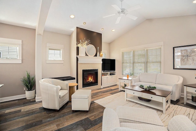 living room featuring a tile fireplace, wood finished floors, and ceiling fan