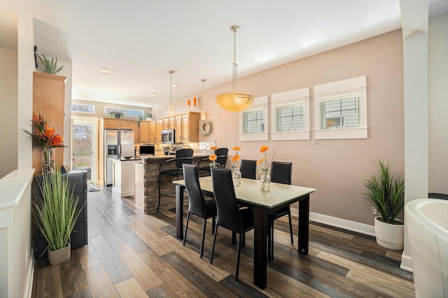 dining space with wood finished floors, recessed lighting, and baseboards