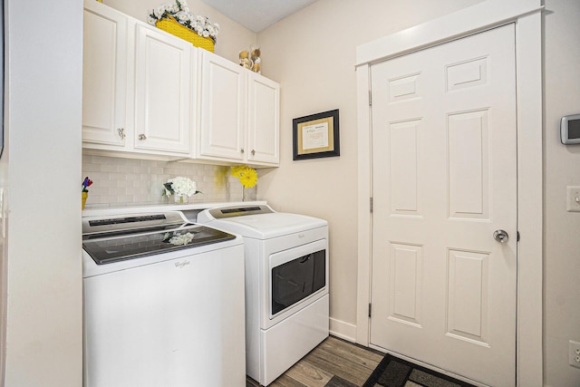 laundry area with washing machine and clothes dryer, cabinet space, and dark wood-style floors