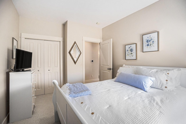 bedroom with light colored carpet and a closet