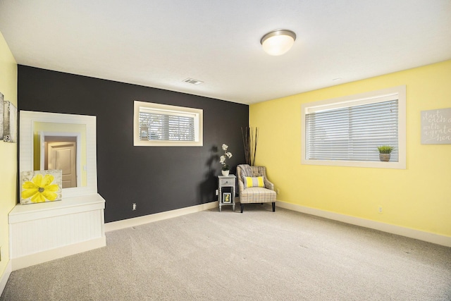 sitting room featuring visible vents, carpet flooring, and baseboards