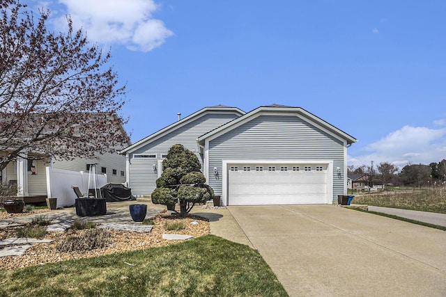ranch-style house with concrete driveway and an attached garage