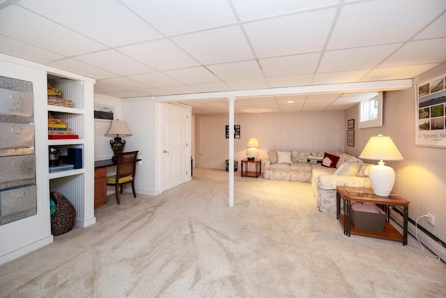 5009 John Holmes Rd, Ann Arbor, MI 48103 - living area featuring carpet flooring, a baseboard heating unit, and a paneled ceiling