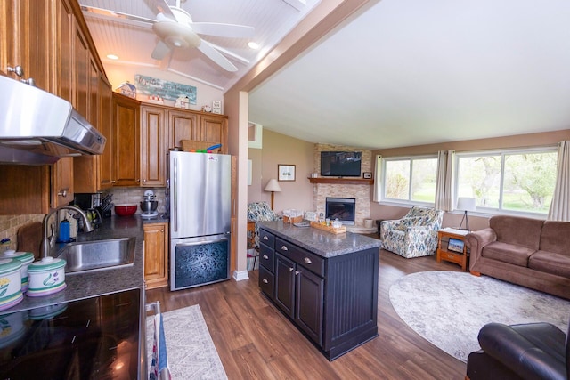 5009 John Holmes Rd, Ann Arbor, MI 48103 - kitchen featuring open floor plan, freestanding refrigerator, vaulted ceiling, exhaust hood, and a sink