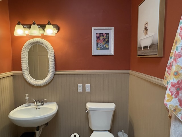 5009 John Holmes Rd, Ann Arbor, MI 48103 - half bathroom featuring wainscoting, a sink, and toilet