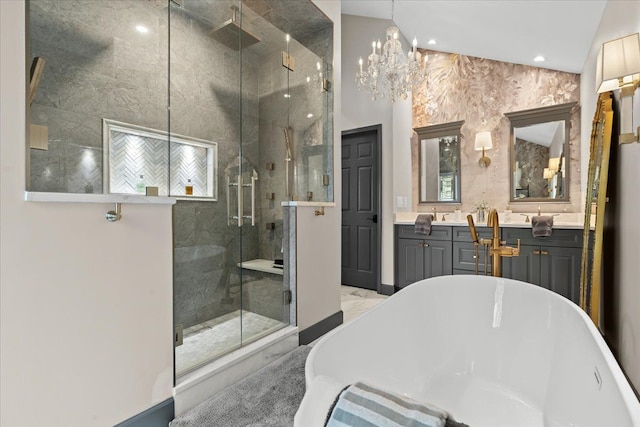 bathroom featuring a shower stall, a freestanding bath, vanity, recessed lighting, and a chandelier