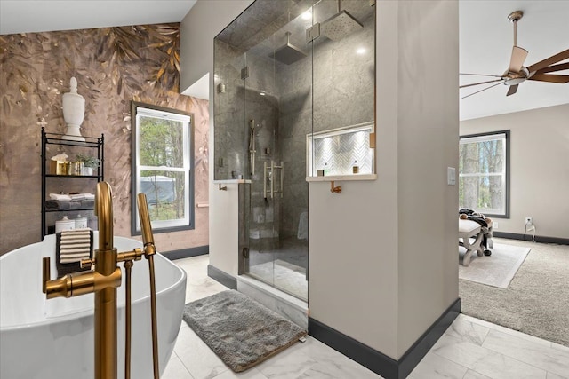 bathroom with marble finish flooring, a shower stall, and plenty of natural light