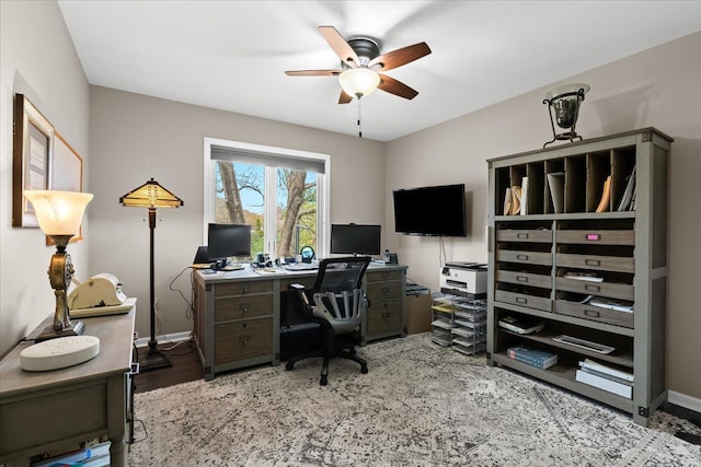 home office with ceiling fan, baseboards, and light wood finished floors