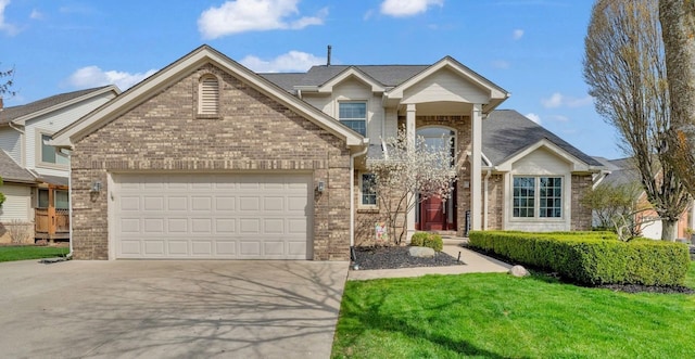 traditional-style home featuring a front yard, driveway, a garage, and brick siding