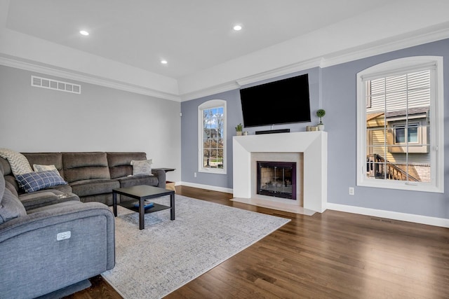 living area featuring baseboards, visible vents, dark wood-style floors, and recessed lighting
