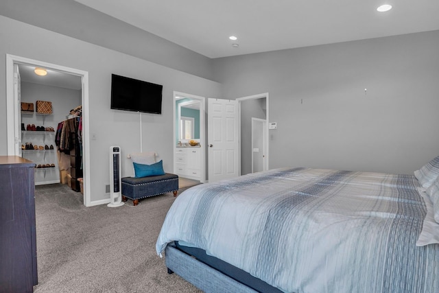 carpeted bedroom with lofted ceiling, a closet, baseboards, recessed lighting, and a walk in closet