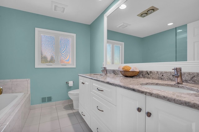 bathroom with visible vents, toilet, baseboards, and a sink