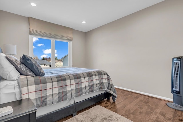 bedroom featuring baseboards, recessed lighting, and wood finished floors