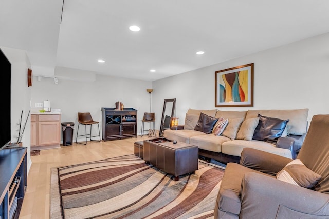 living room featuring light wood-type flooring and recessed lighting