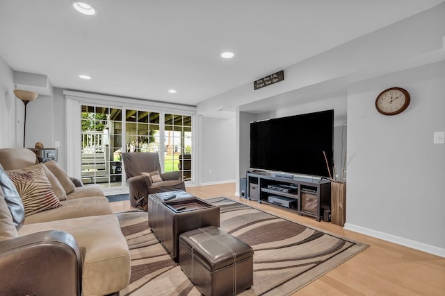 living room with baseboards, recessed lighting, and wood finished floors
