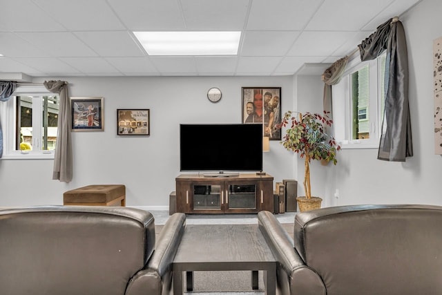 living room featuring a paneled ceiling