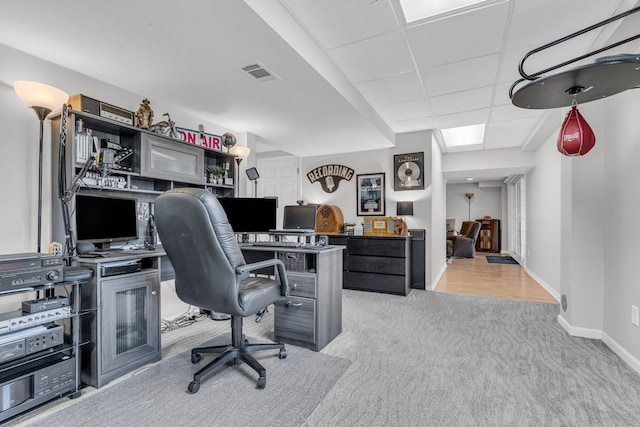 carpeted office with baseboards and visible vents