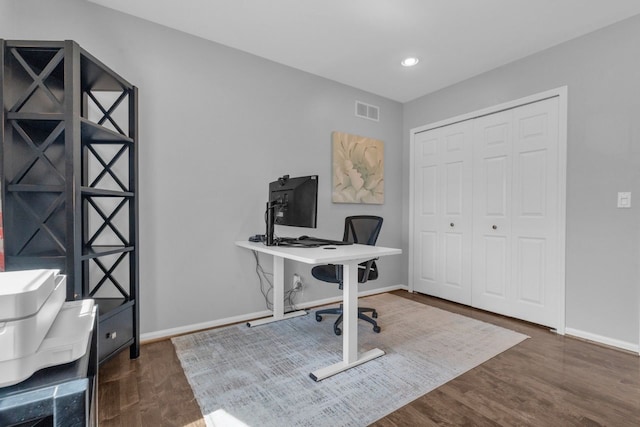 office featuring baseboards, visible vents, wood finished floors, and recessed lighting