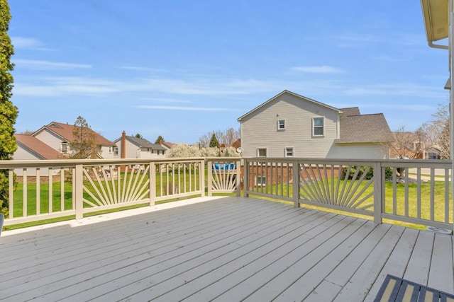 wooden deck with a residential view and a lawn