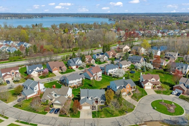 birds eye view of property with a residential view and a water view