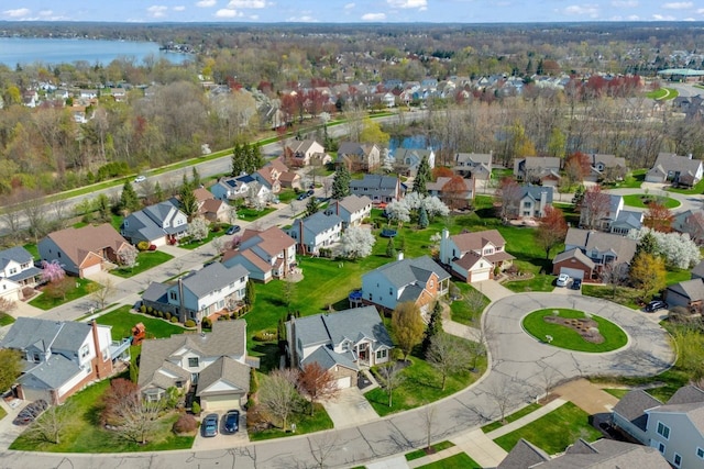 birds eye view of property with a water view and a residential view