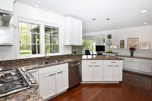 kitchen with dishwasher, a sink, a peninsula, dark wood-style floors, and white cabinetry