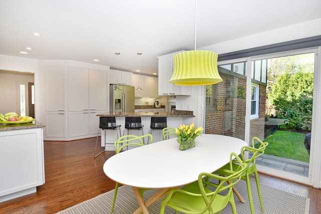 dining room with recessed lighting, plenty of natural light, and dark wood-style floors