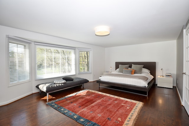 bedroom featuring baseboards and wood finished floors