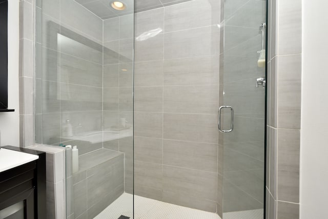 full bath featuring vanity and a shower stall