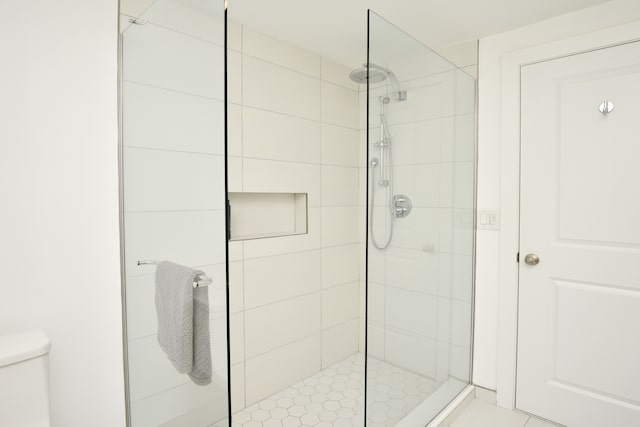 full bath featuring toilet and a shower stall