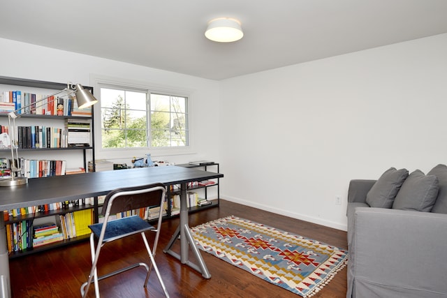 home office with baseboards and wood finished floors