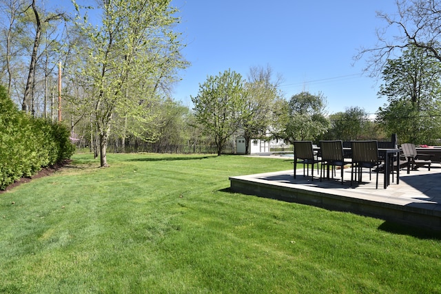 view of yard with fence, an outdoor structure, and a patio area