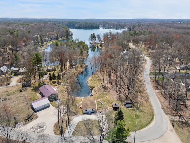 aerial view with a wooded view and a water view