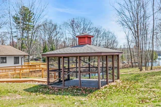 exterior space with a lawn, a deck, and a gazebo