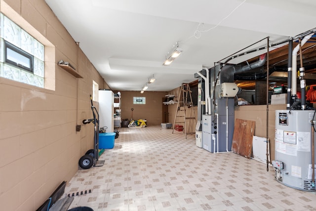 below grade area featuring tile patterned floors and water heater