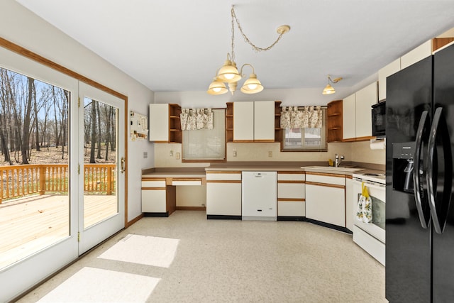 kitchen featuring black appliances, pendant lighting, a healthy amount of sunlight, and open shelves