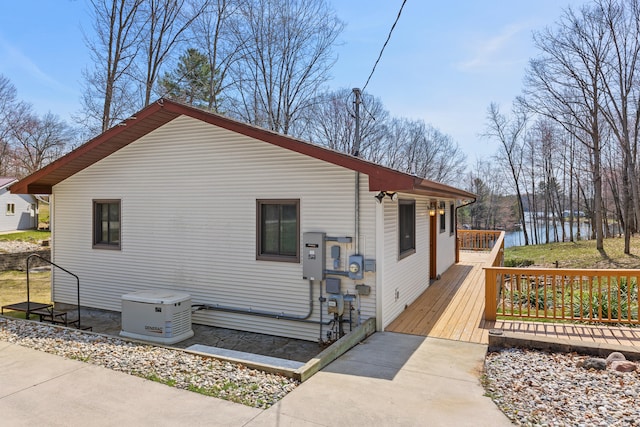 exterior space with a deck with water view