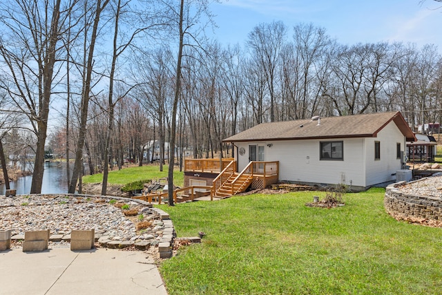 rear view of house featuring a deck, a lawn, central AC, and stairs