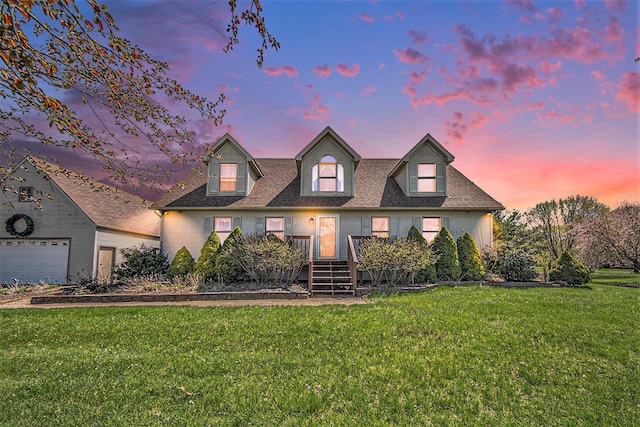cape cod home with roof with shingles and a front lawn